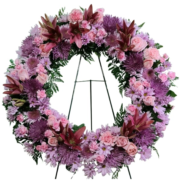 Pink and purple floral wreath on a metal stand