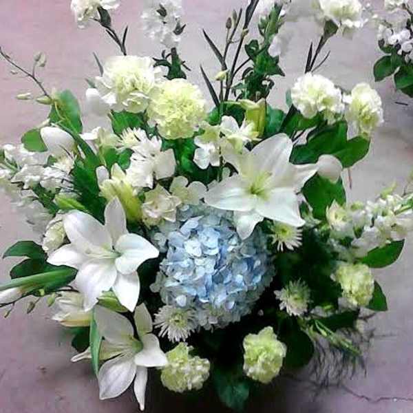 White lilies and hydrangea in a low floral arrangement