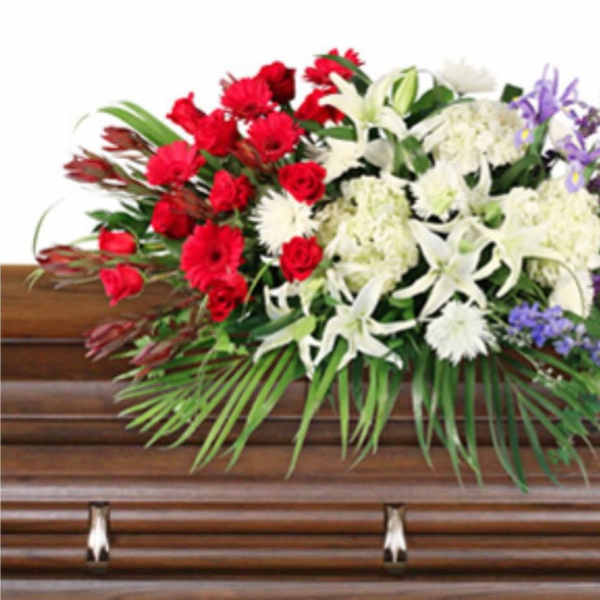 Casket spray with red, white, and purple flowers