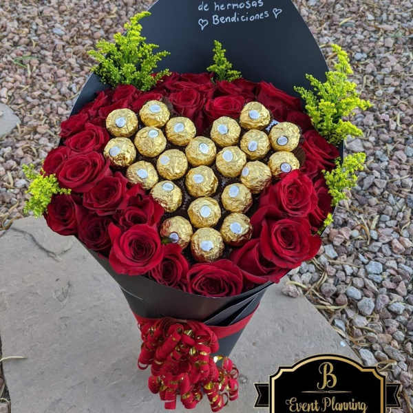 Heart-shaped bouquet of red roses with gold-wrapped chocolates and a black card