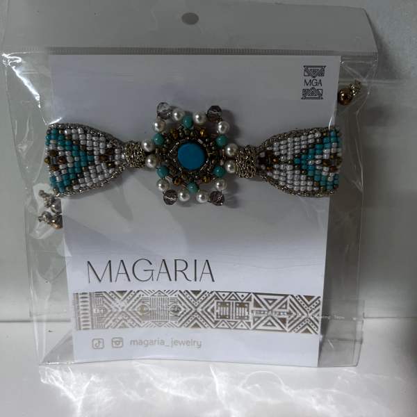 Beaded bow-shaped jewelry on a card in clear packaging