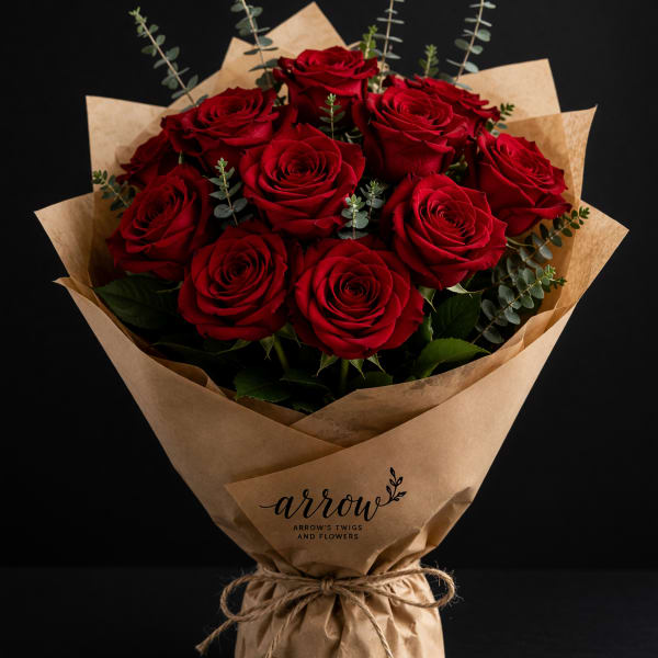 Bouquet of red roses wrapped in brown paper with twine