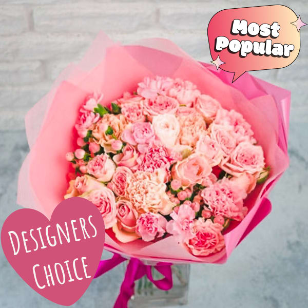 Pink bouquet of mixed roses and carnations wrapped in pink paper