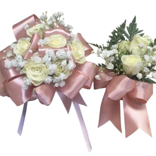 Two small rose bouquets wrapped with pink satin ribbon