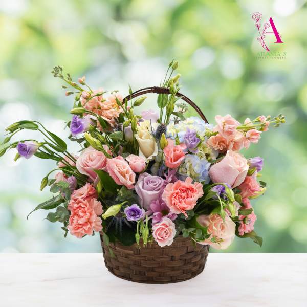 Basket of pastel roses, carnations, and lisianthus