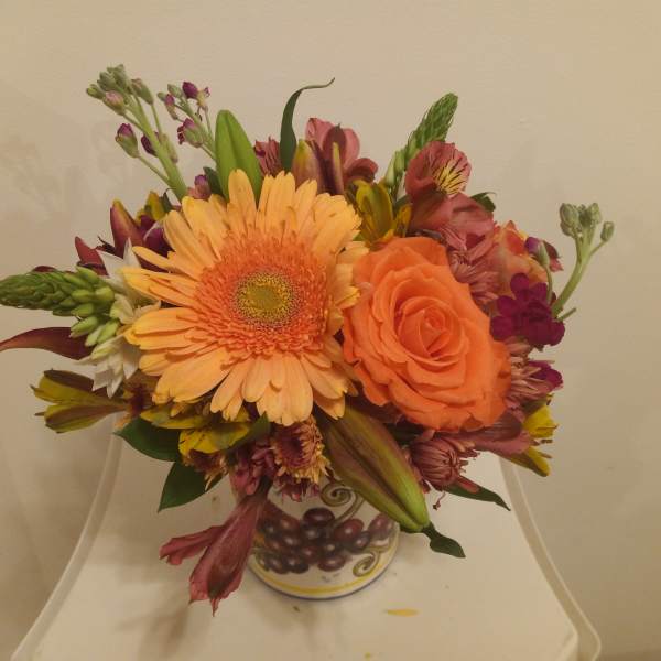 Mixed bouquet with orange gerbera daisy and rose in a decorative vase