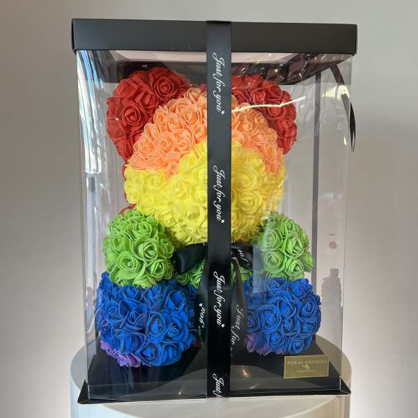 Rainbow teddy bear made of roses in a clear gift box