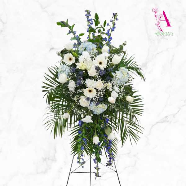 Tall white and blue floral standing spray on an easel