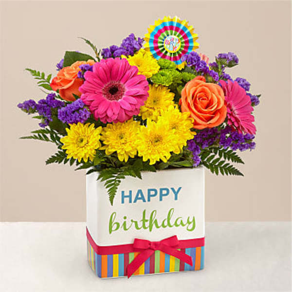 Colorful mixed bouquet in a birthday gift box with a ribbon
