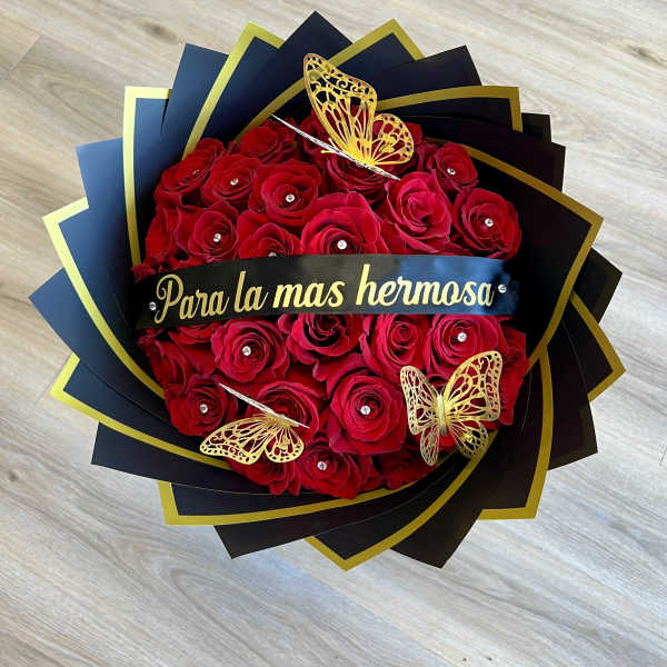 Red rose bouquet with gold butterfly decorations and a black ribbon