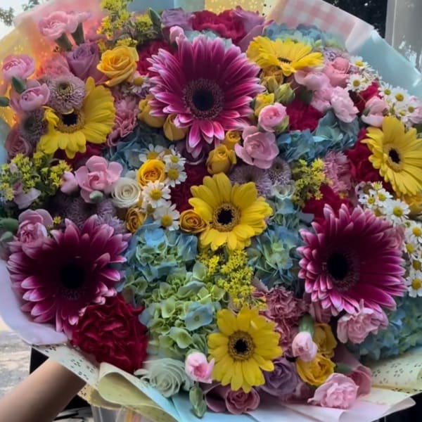 Large mixed bouquet with gerbera daisies, roses, and pastel flowers