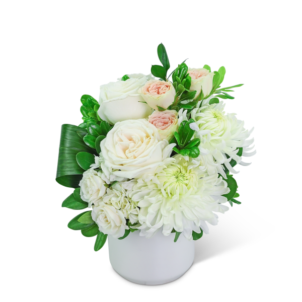 White and blush roses with white chrysanthemums in a white vase