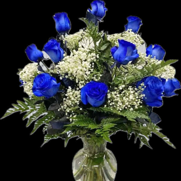 Blue roses and white filler flowers in a clear glass vase