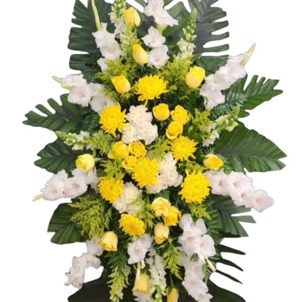 Standing floral spray with yellow roses, white chrysanthemums, and white gladiolus