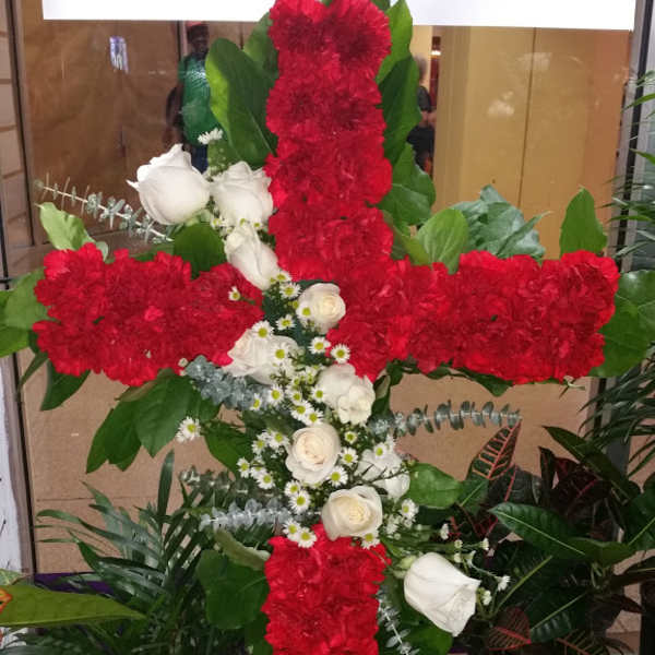 Red and white floral cross arrangement with roses