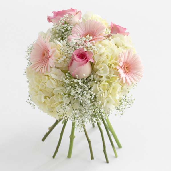 Bouquet of pink and cream flowers with a central rose