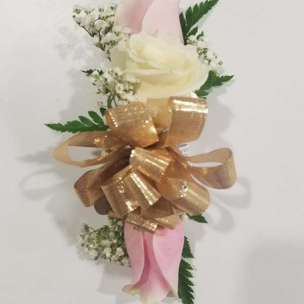 Pink and white calla lily corsage with gold ribbon