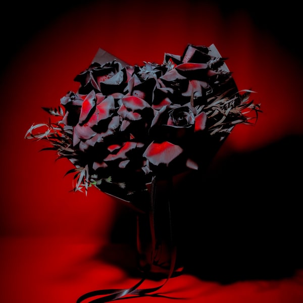 Dark bouquet with black and red flowers tied with a black ribbon
