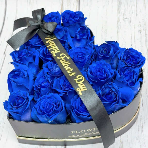 Heart-shaped box of blue roses with a black ribbon