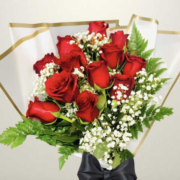 Bouquet of red roses with white baby's breath and a black ribbon