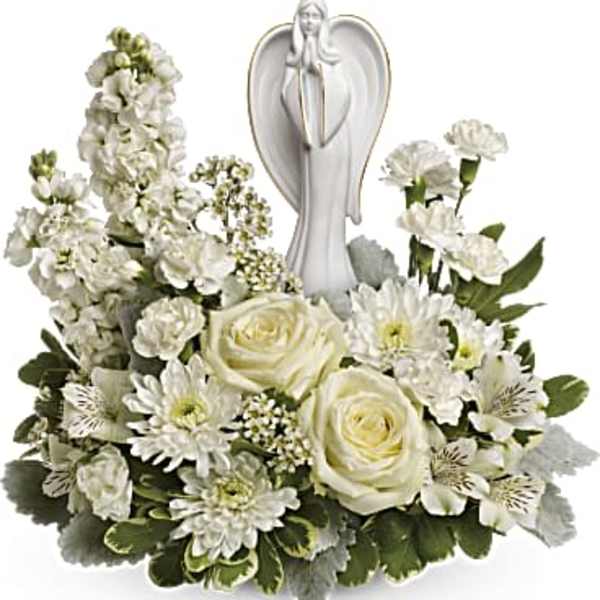 White floral arrangement with an angel figurine in the center