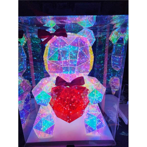 Iridescent teddy bear display with a red heart and bow