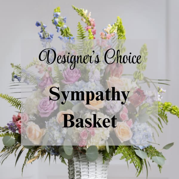 Sympathy basket of pastel flowers in a white wicker basket
