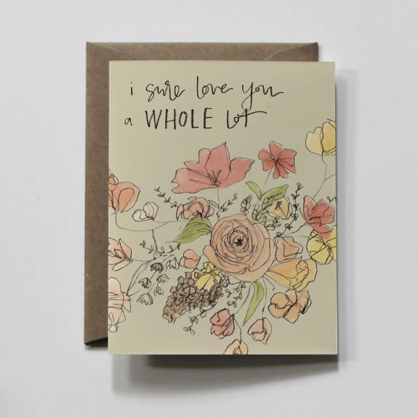 Floral greeting card with handwritten text on a kraft envelope