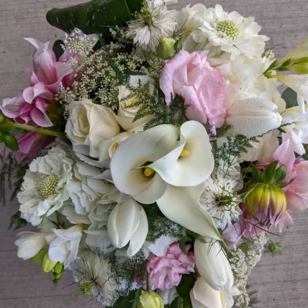 Bouquet of white calla lilies, roses, and pink flowers