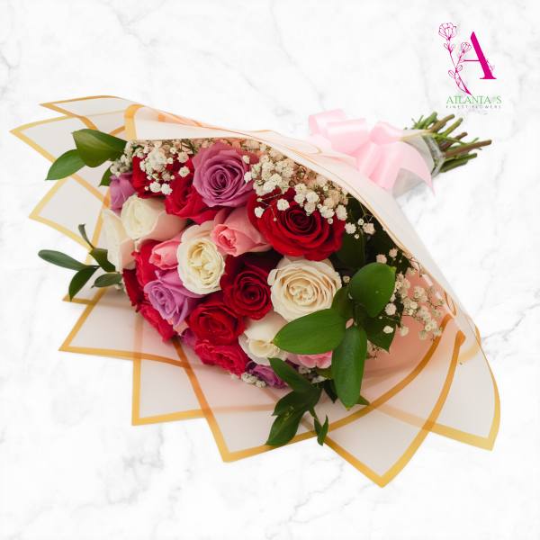 Bouquet of pink, red, and white roses wrapped in translucent paper