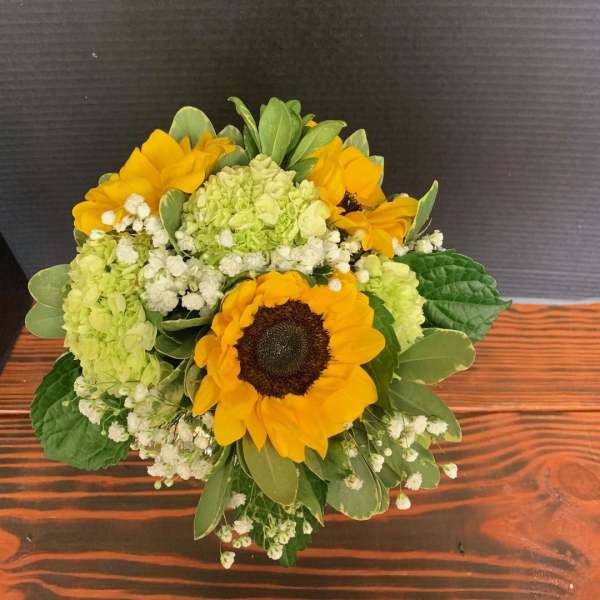 Bouquet of yellow sunflowers with green hydrangeas and white filler flowers