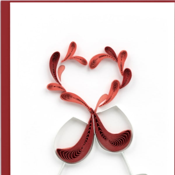 Two wine glasses with a red paper heart design on a white card