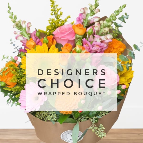 Wrapped bouquet of pink, orange, and yellow flowers