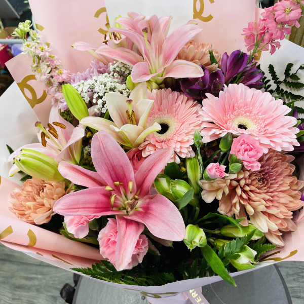 Pink lily and gerbera bouquet in pastel wrapping