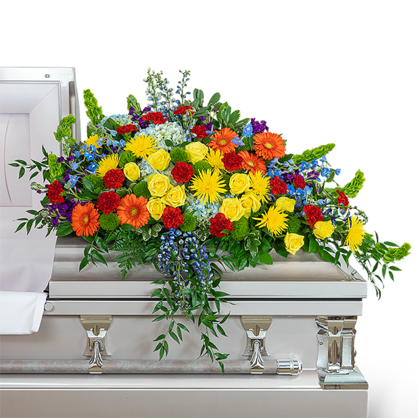 Colorful floral spray on a silver casket