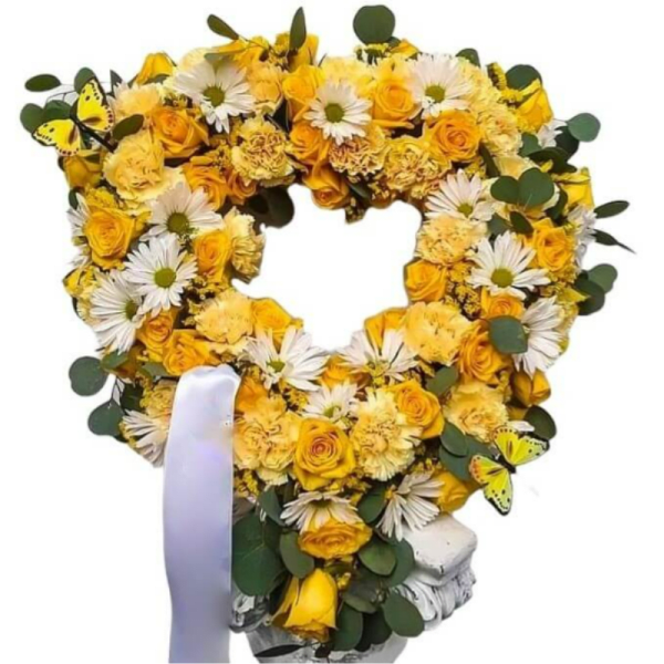 Heart-shaped yellow flower wreath with white daisies and ribbon