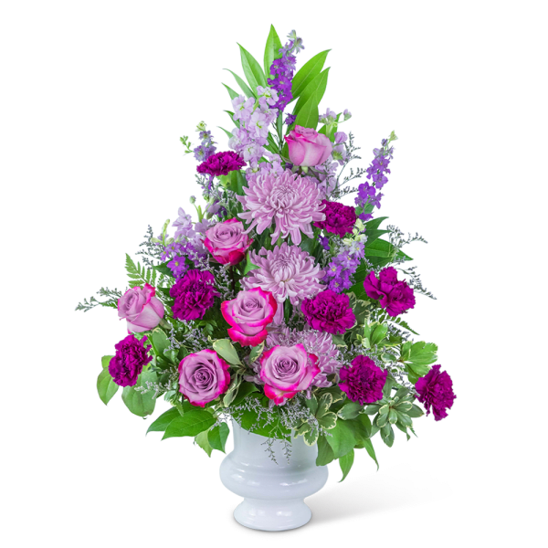 Pink and purple floral arrangement in a white vase