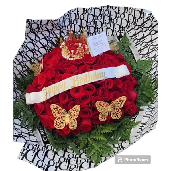 Red rose bouquet with a birthday ribbon, crown topper, and butterfly decorations