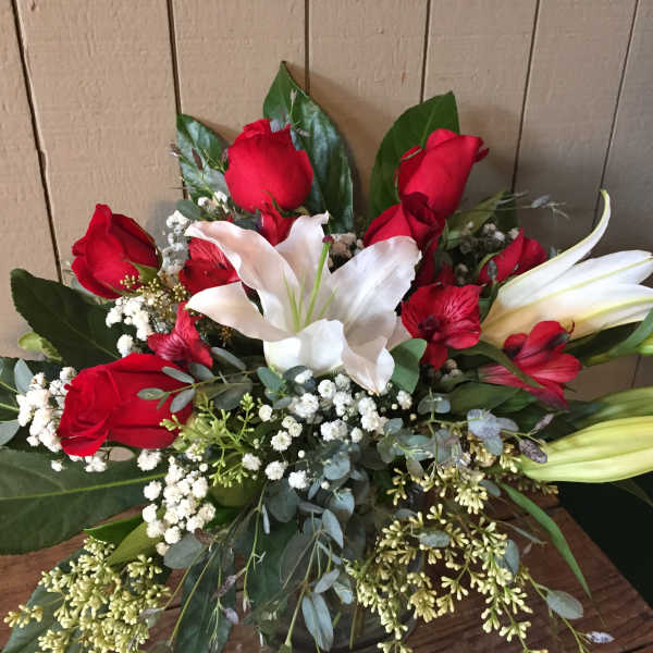 Bouquet of red roses and white lilies with baby's breath