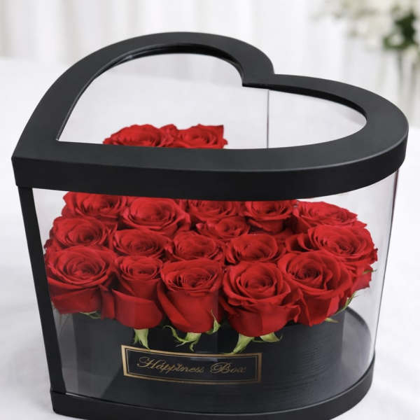 Heart-shaped black box filled with red roses