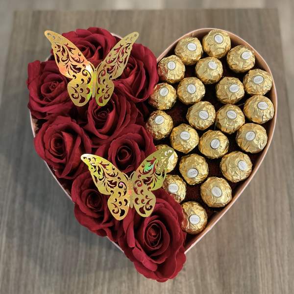 Heart-shaped box with red roses and gold-wrapped chocolates