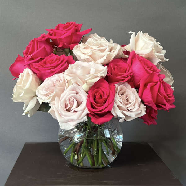 Bouquet of pink and white roses in a clear glass vase