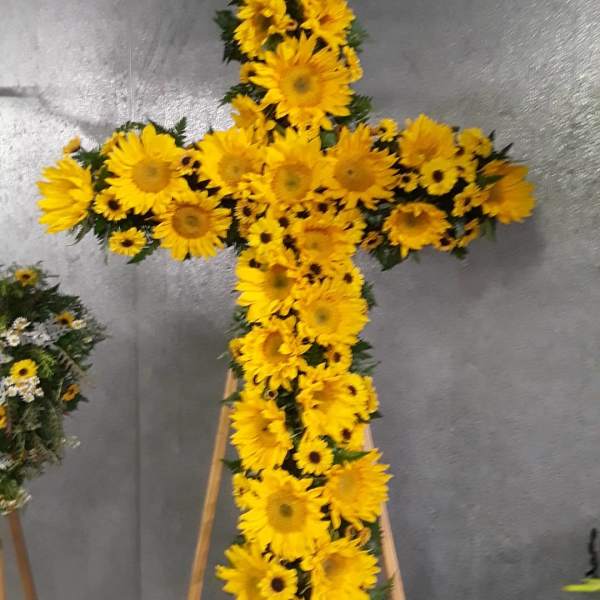 Yellow sunflower cross on a stand
