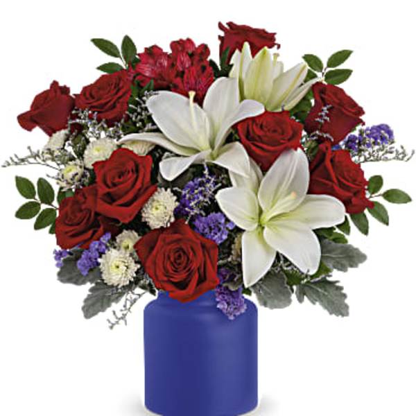 Red roses and white lilies arranged in a blue vase