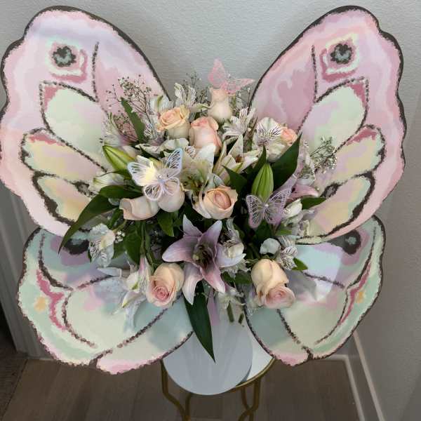Butterfly-shaped bouquet with pale pink roses and lilies