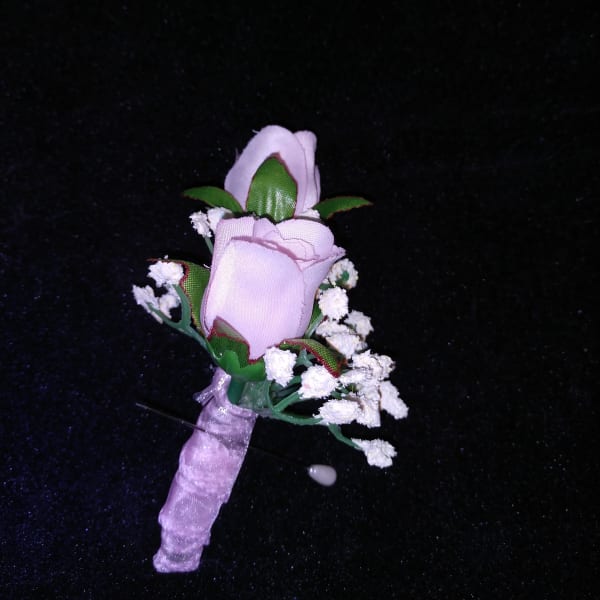 Small lavender rose boutonniere with white filler flowers