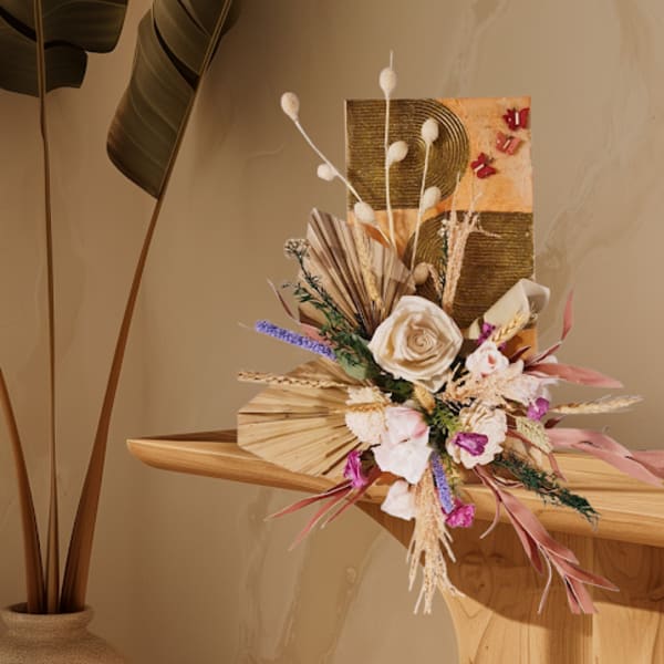 Dried floral arrangement with cream roses and pink accents on a wooden shelf