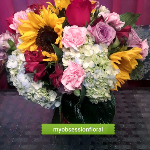 Mixed bouquet with sunflowers, roses, hydrangeas, and carnations