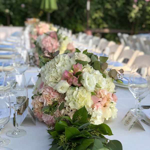 Pastel floral centerpiece on a long banquet table