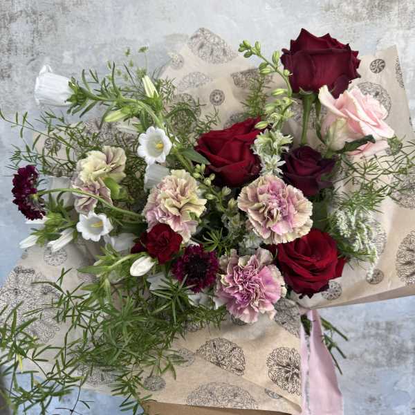 Bouquet of red and pink roses with carnations and white blooms